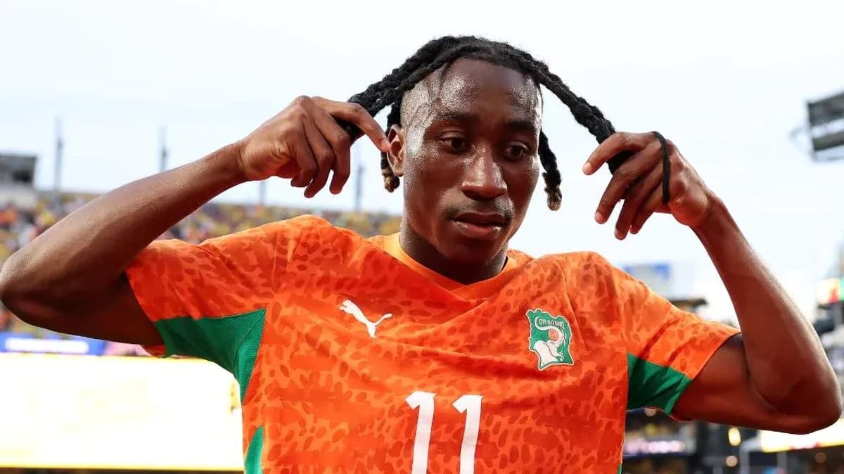 Player adjusting hair after match in orange jersey