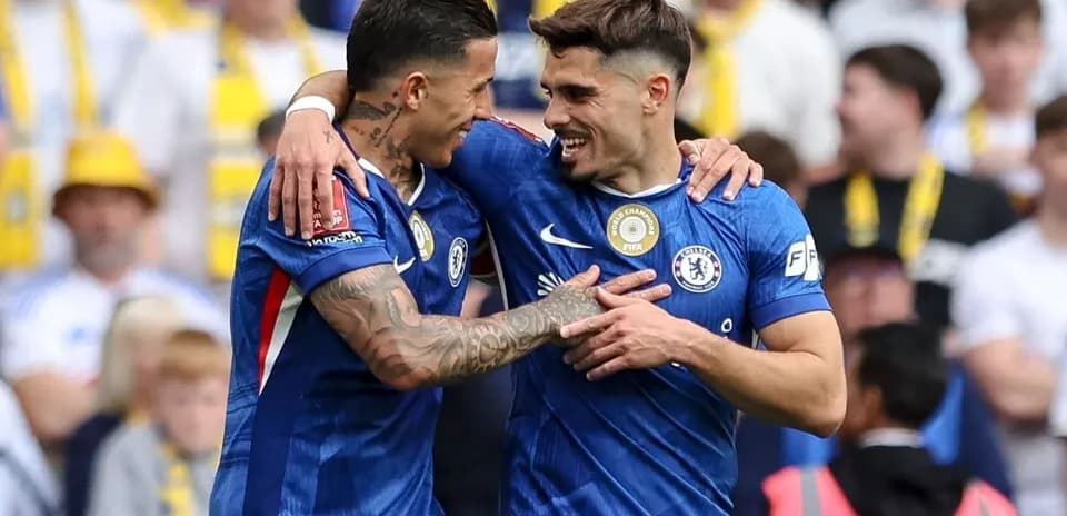 Two Chelsea players celebrating a goal together