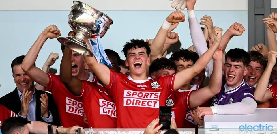 Team celebrating victory with trophy raised high