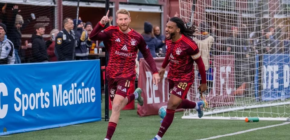 Players celebrating goal in Detroit City match