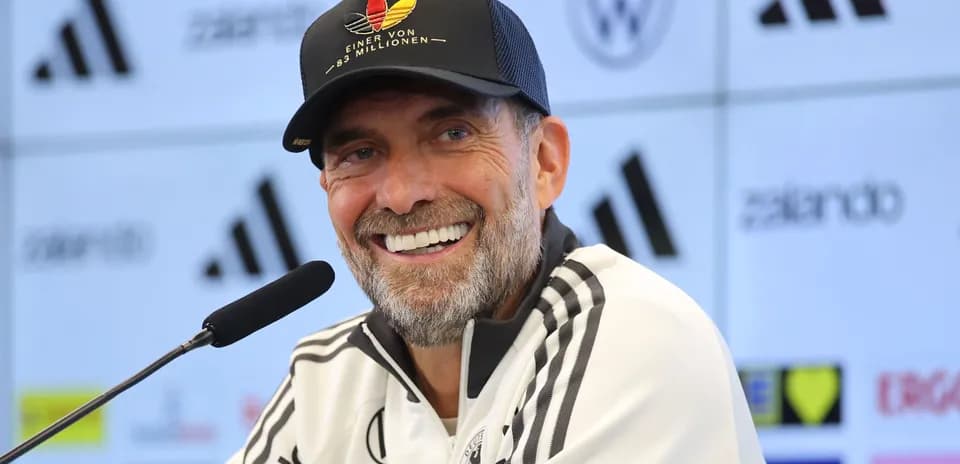 Coach speaking at press conference with microphone