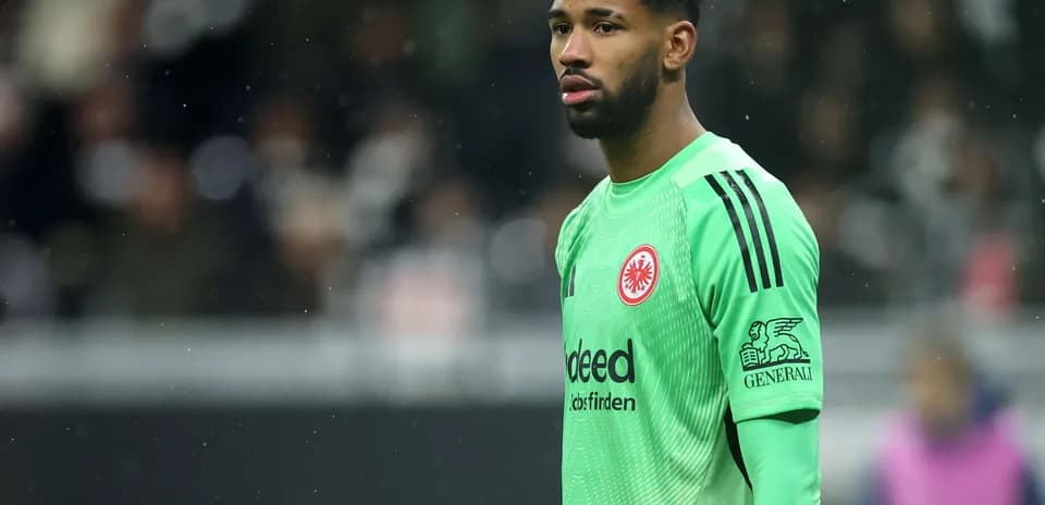 Goalkeeper in green kit during match warm-up