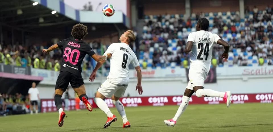 Players competing for the ball during match