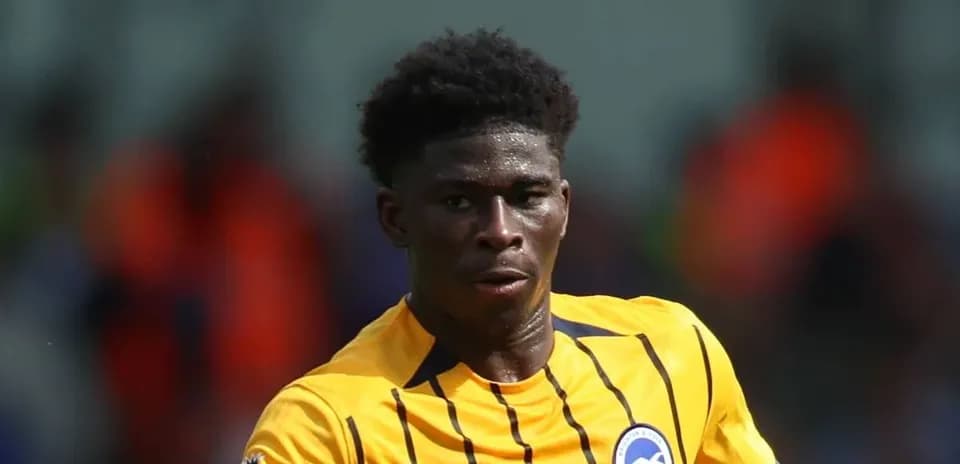 Player in yellow kit running on the field