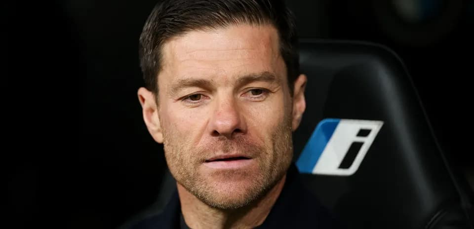 Coach seated on bench during a match