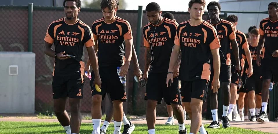 Arsenal players walking together during training session