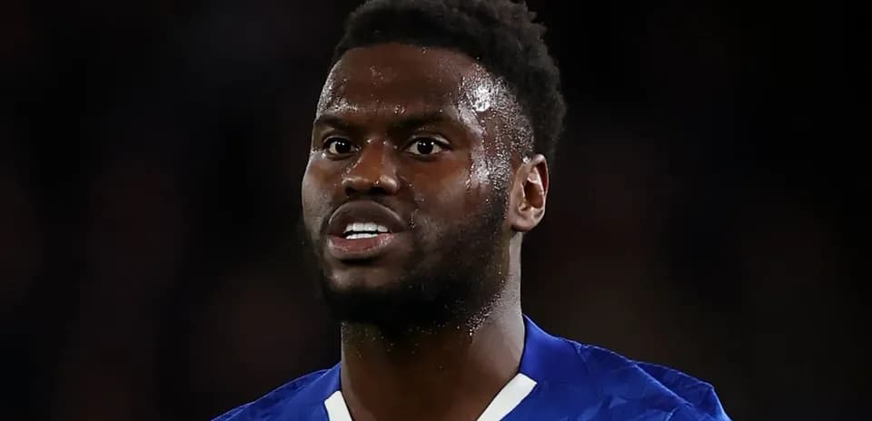 Football player in blue kit during match