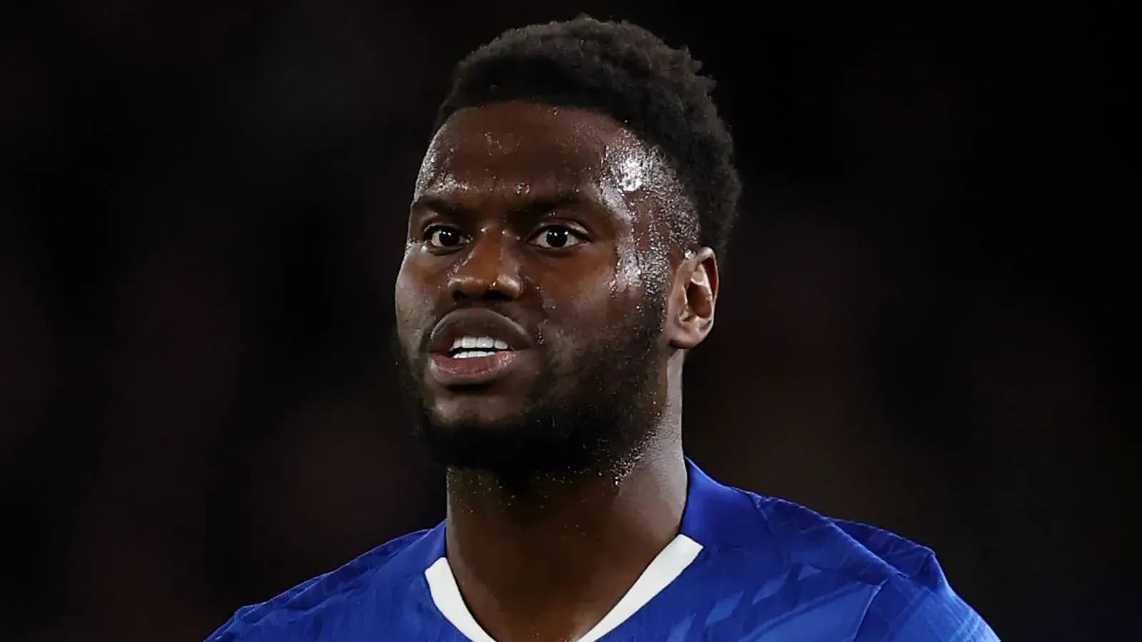 Football player in blue kit during match