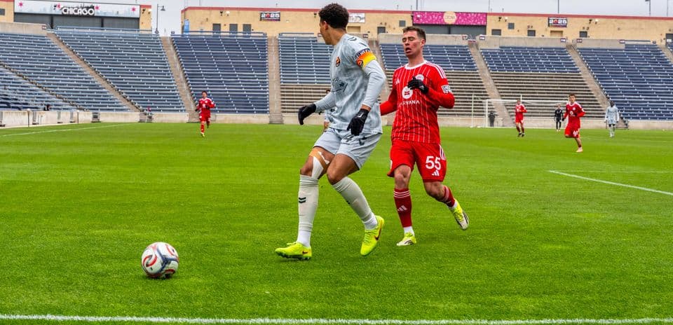 Player dribbling ball during Carolina Core match