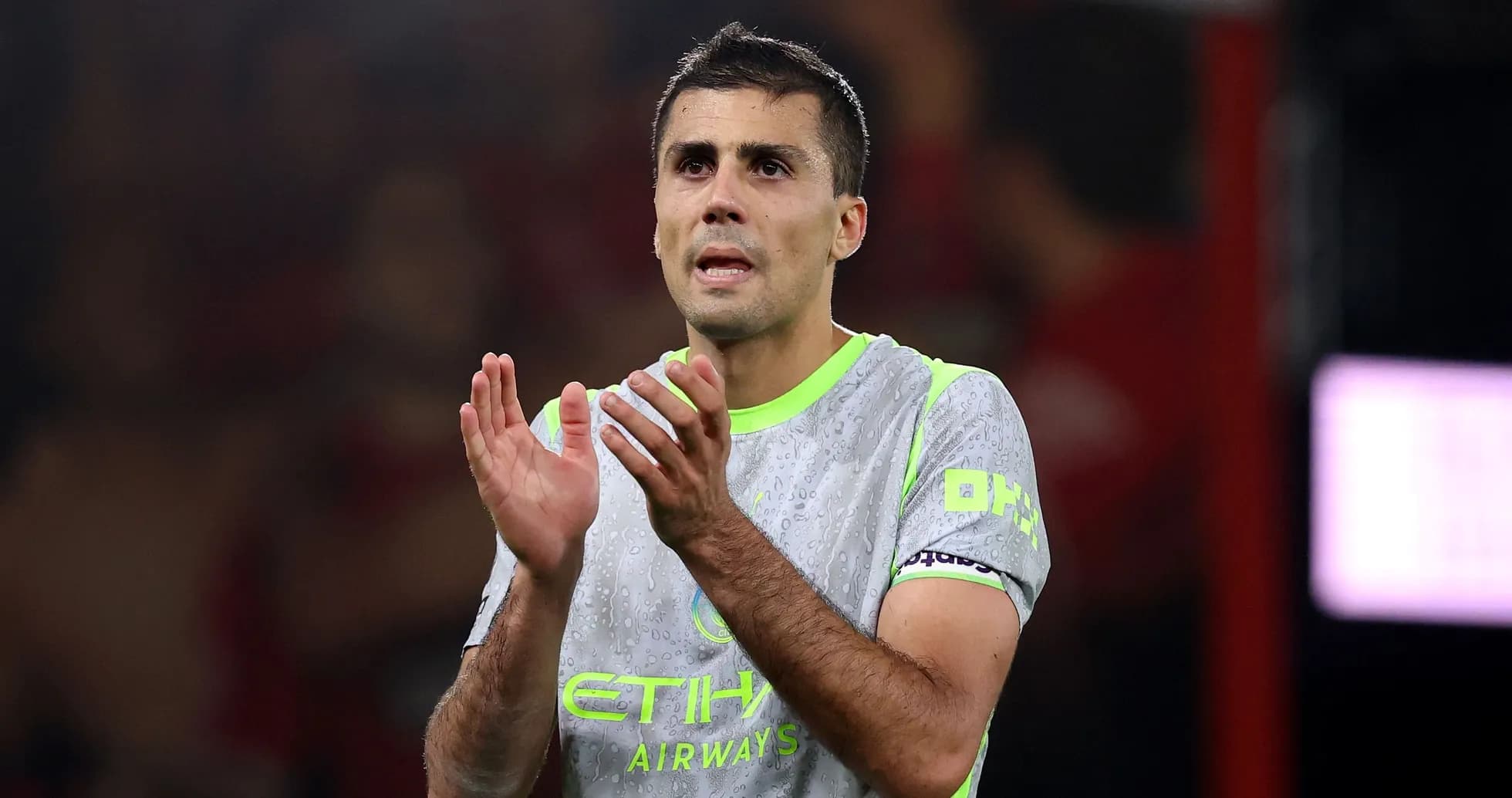 Player applauding in Manchester City kit on pitch
