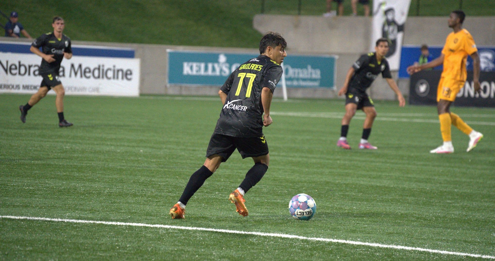 Player dribbling ball during Union Omaha match