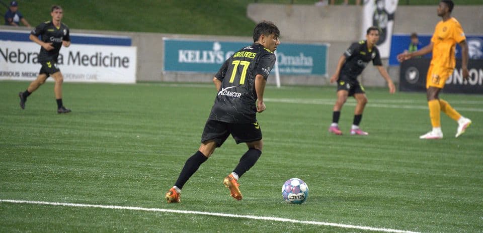 Player dribbling ball during Union Omaha match