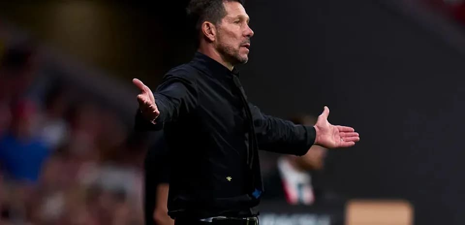 Coach gesturing on the sidelines during match