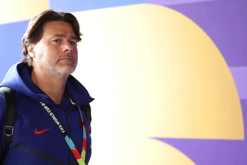 Coach walking in front of colorful backdrop