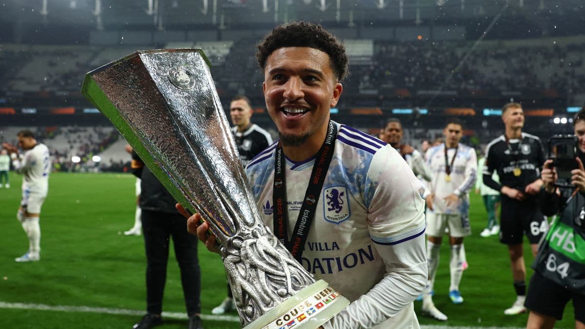 Player celebrating with UEFA trophy on the field