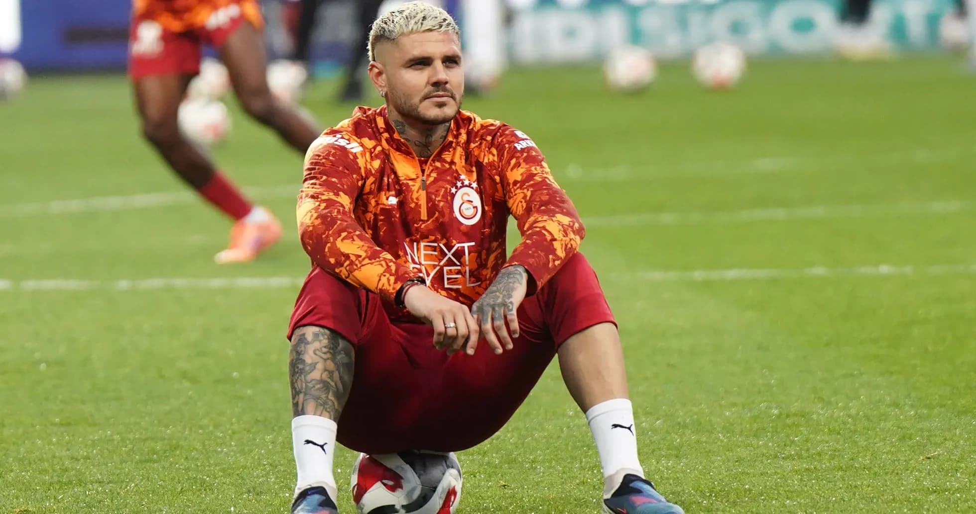 Player sitting on the field during warm-up session