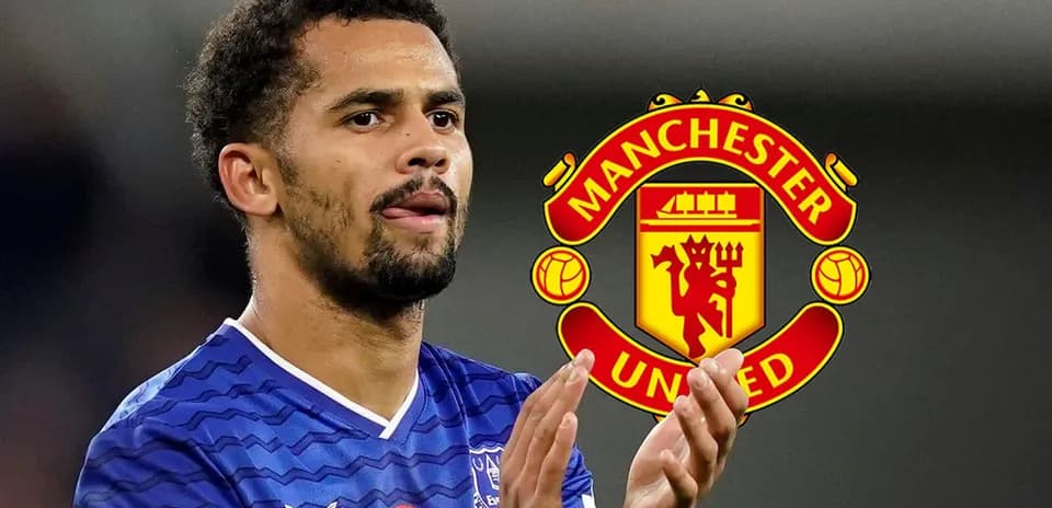 Player applauding with Manchester United logo in background