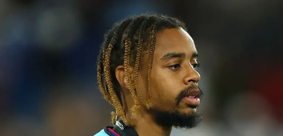 Player with braided hair wearing a team jersey