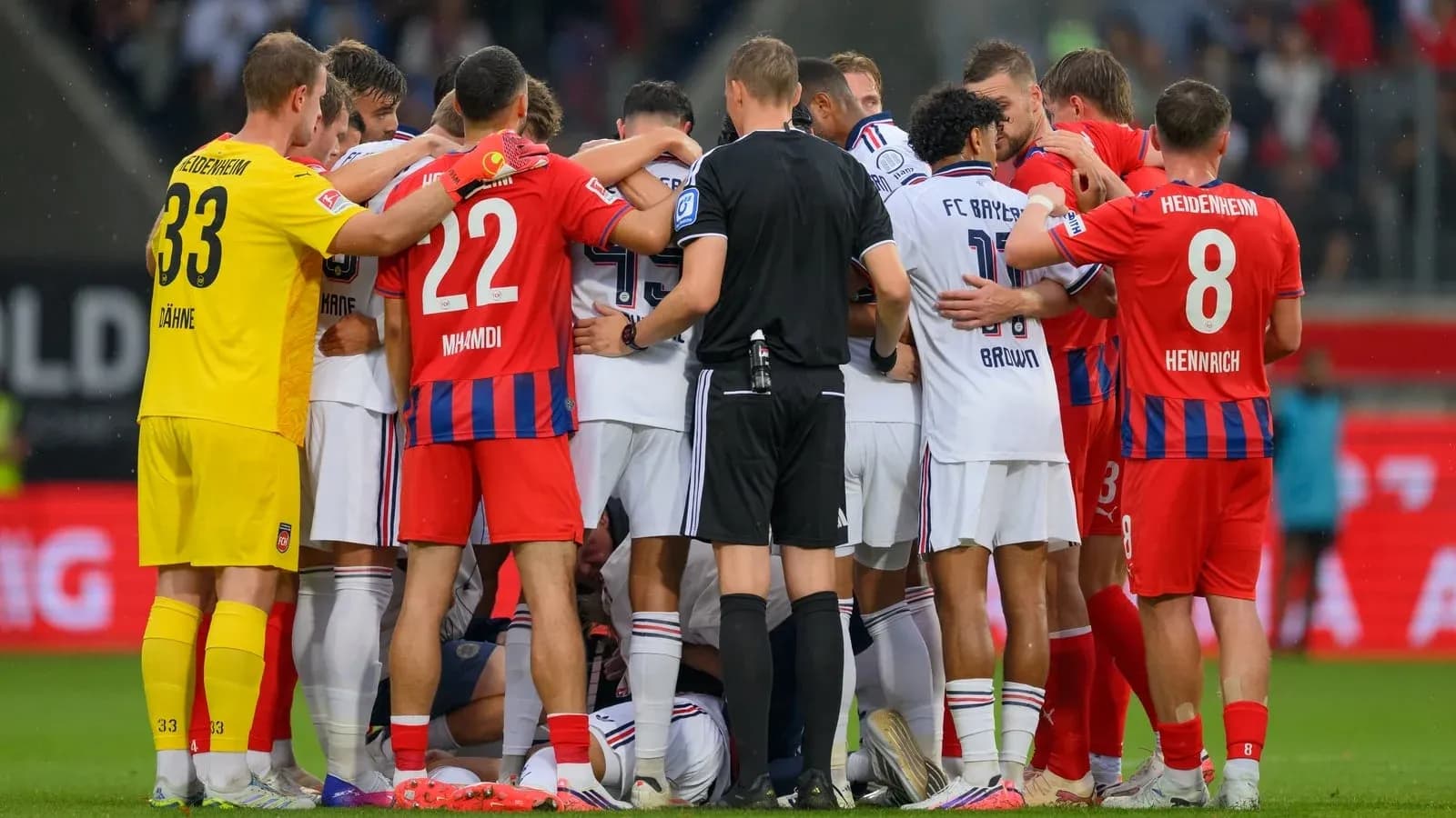 Players from both teams huddled during stoppage