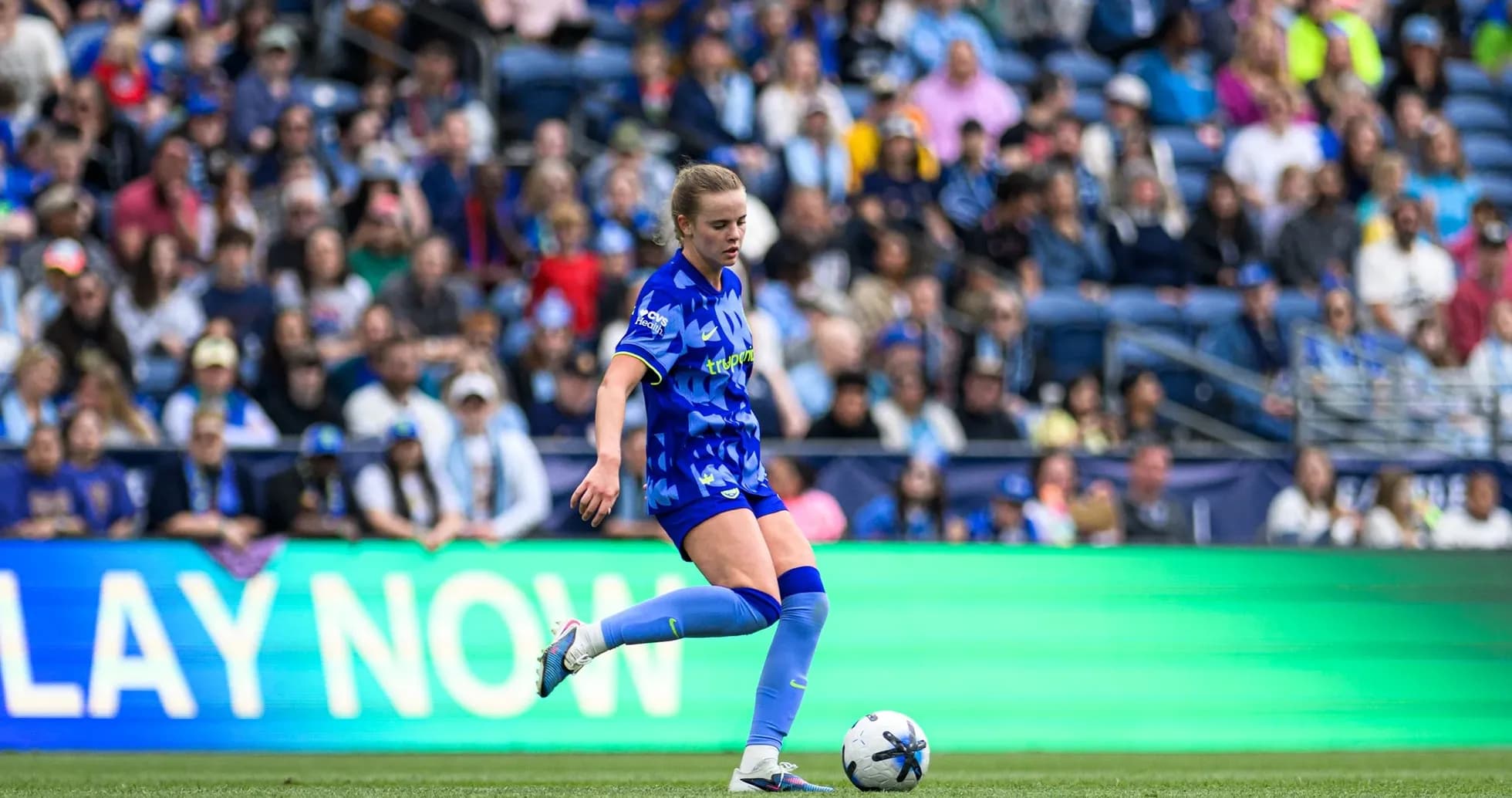 Player kicking ball during Seattle Reign FC match