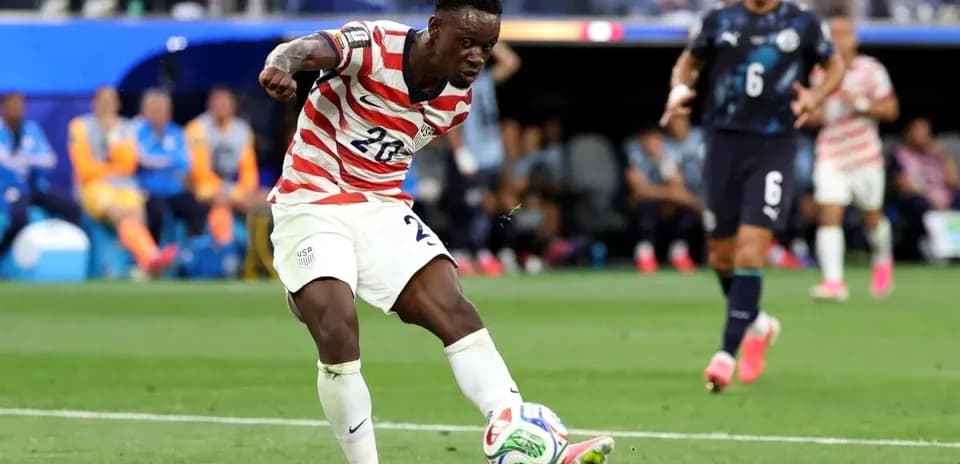 Player in USA kit preparing to kick soccer ball