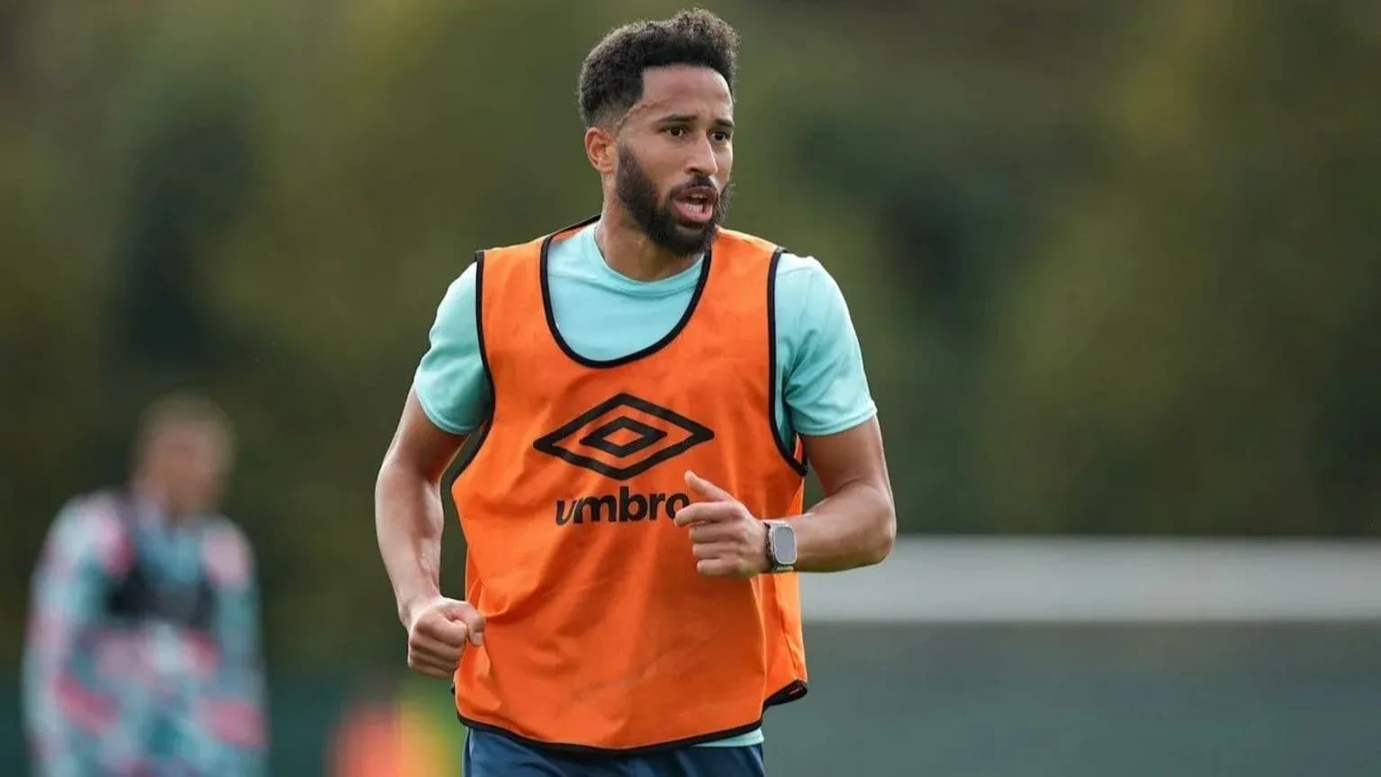 Player training in orange bib during practice session