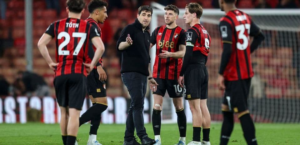 Manager discussing strategy with players on field