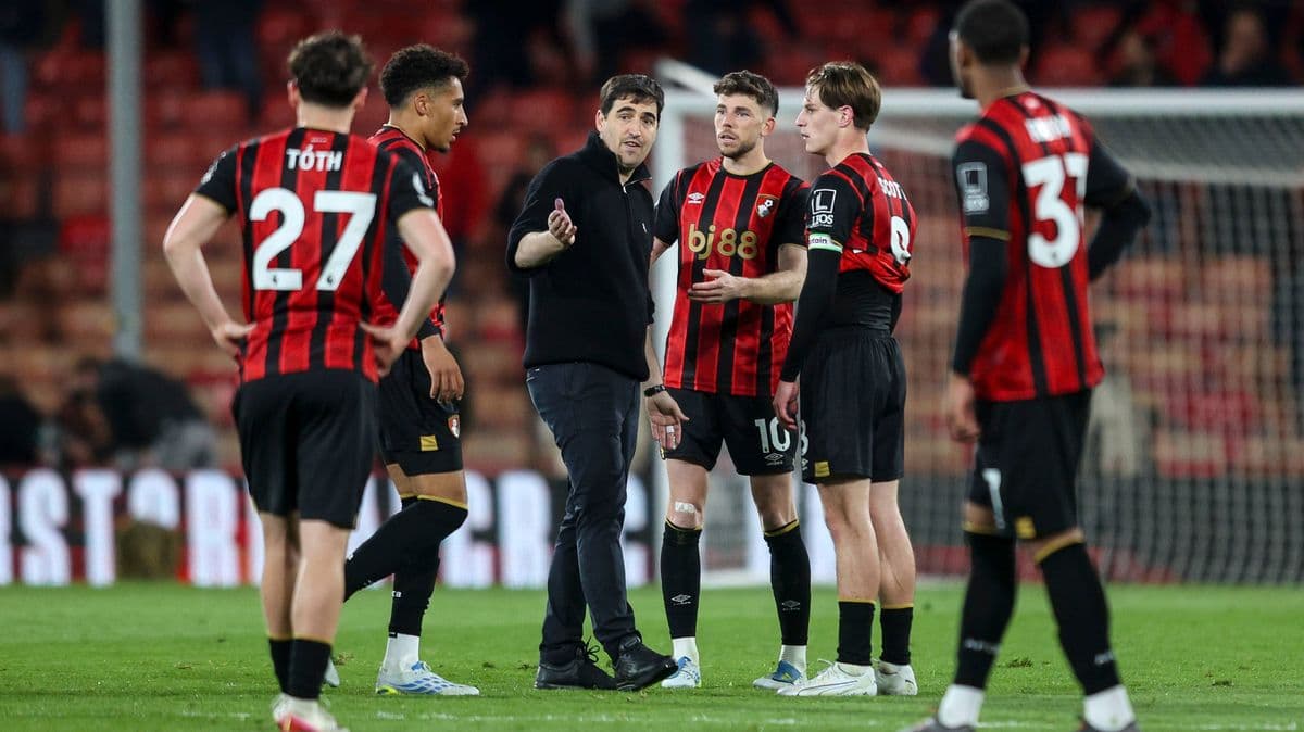 Manager discussing strategy with players on field