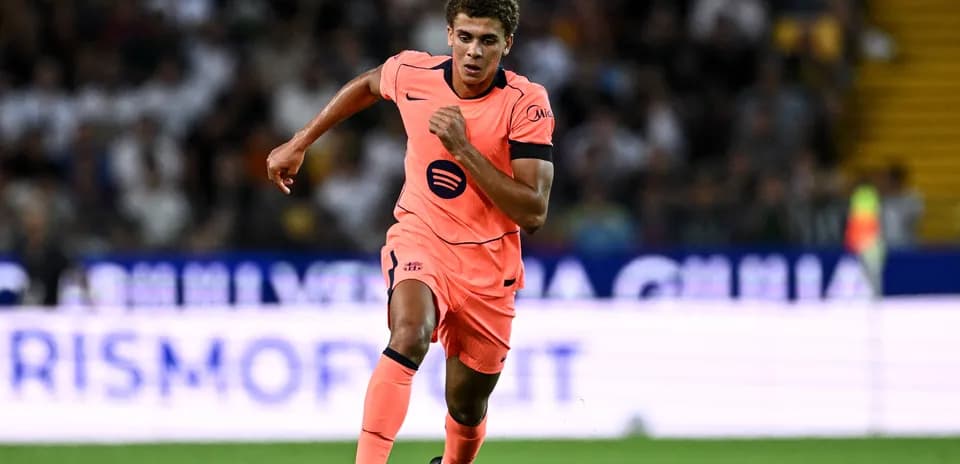 Player running on the pitch in bright jersey