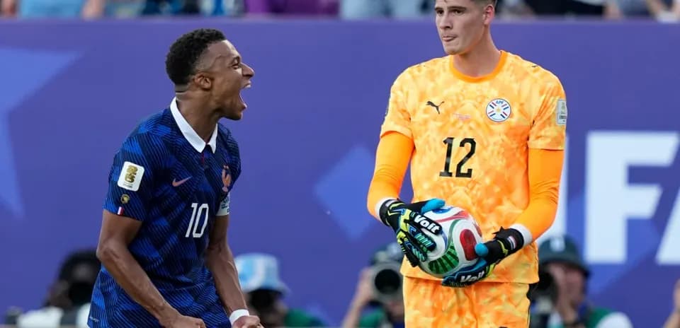 French player celebrating while goalkeeper holds ball