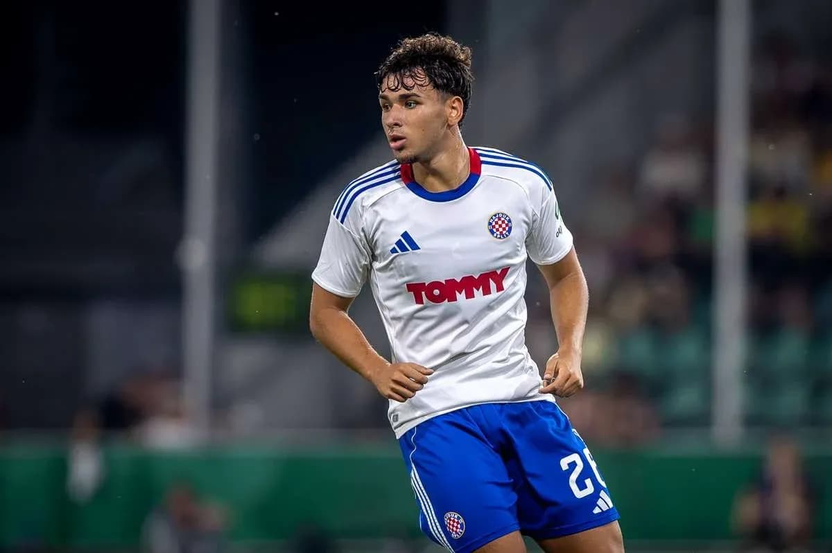 Player in action wearing white and blue kit