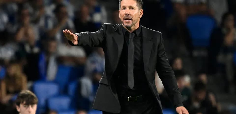 Coach gesturing during a football match on sideline