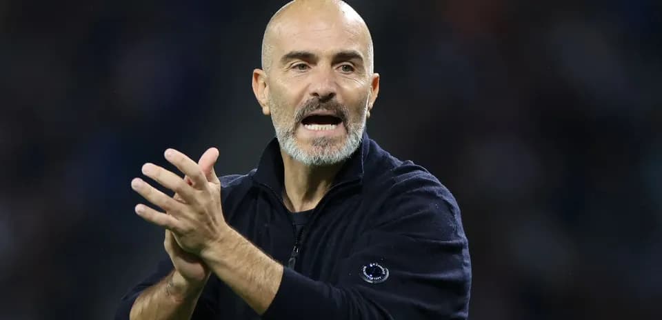 Manager gesturing and clapping on the sidelines