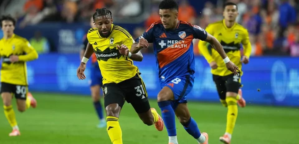 Two players competing for the ball in football match