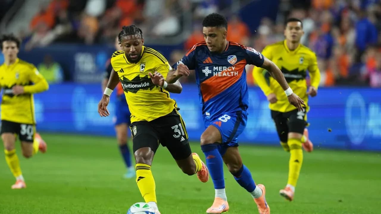 Two players competing for the ball in football match