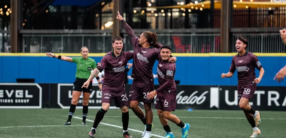 Players celebrating a goal during football match