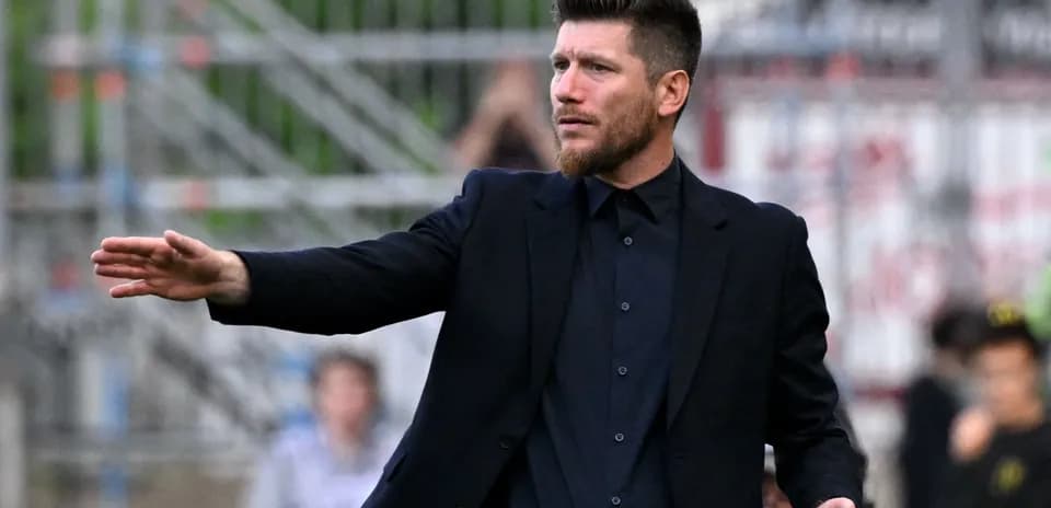 Coach gesturing from the sidelines during match
