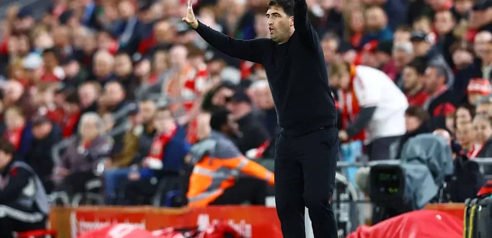Coach directing players during a football match