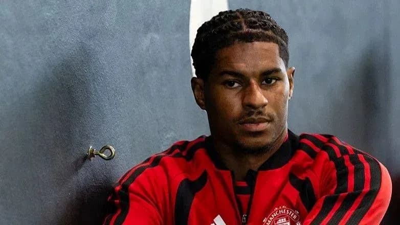 Player in Manchester United training attire posing