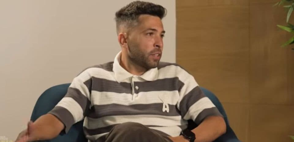 Man speaking while seated in a chair