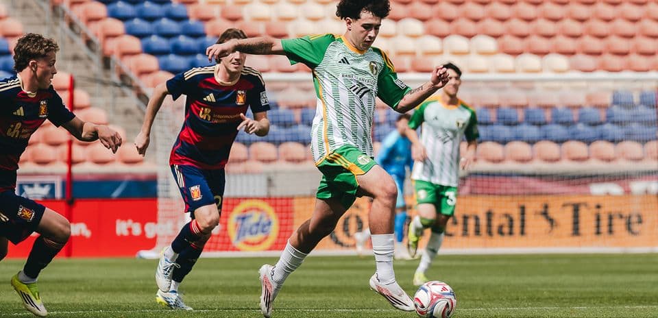 Player dribbling the ball in MLS Next Pro match