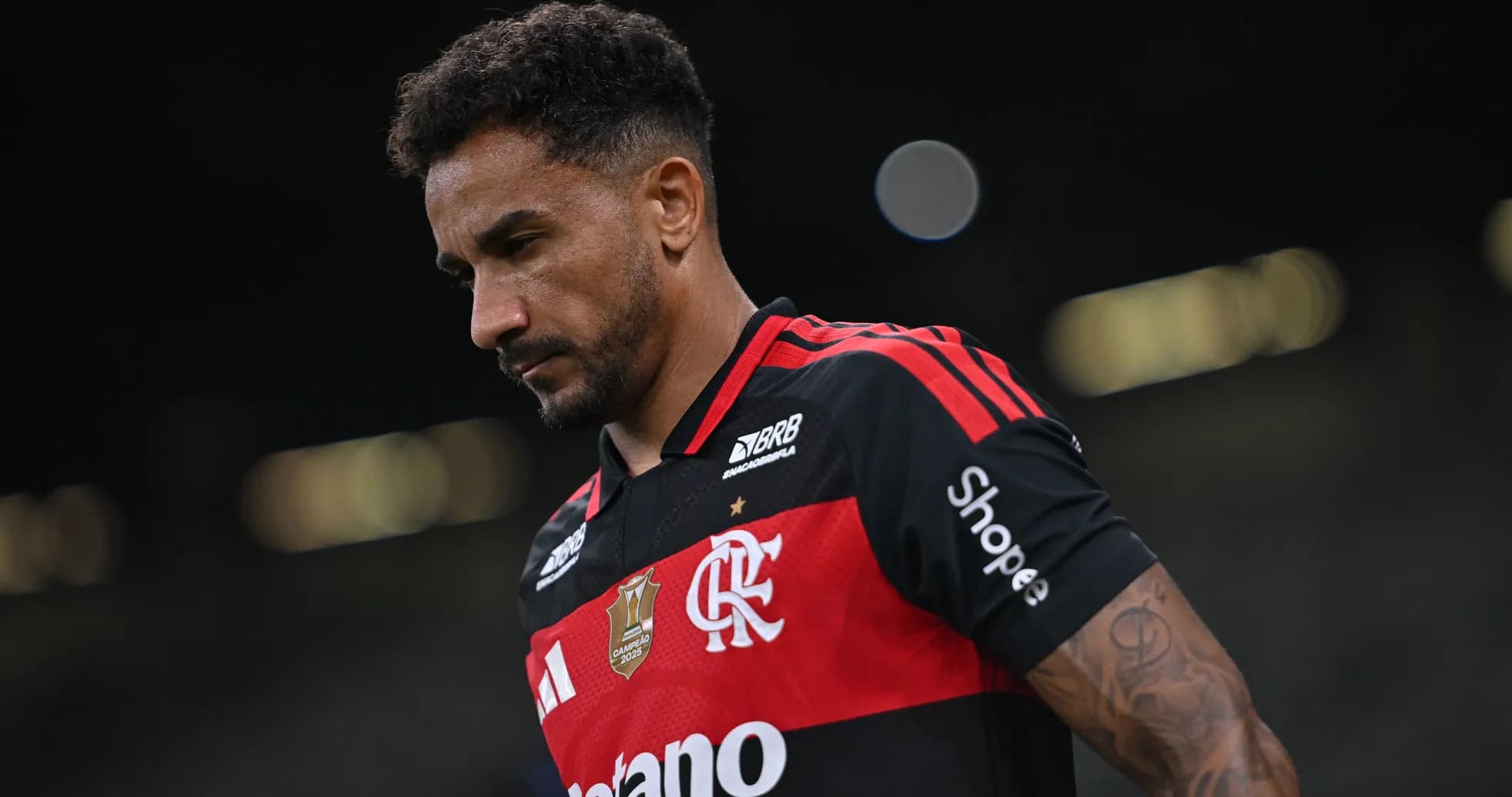 Player in Flamengo jersey walking off the field