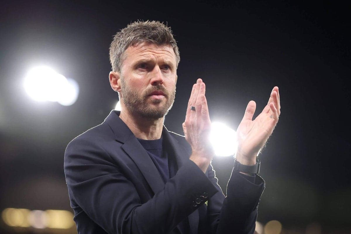 Coach applauding during a match at night