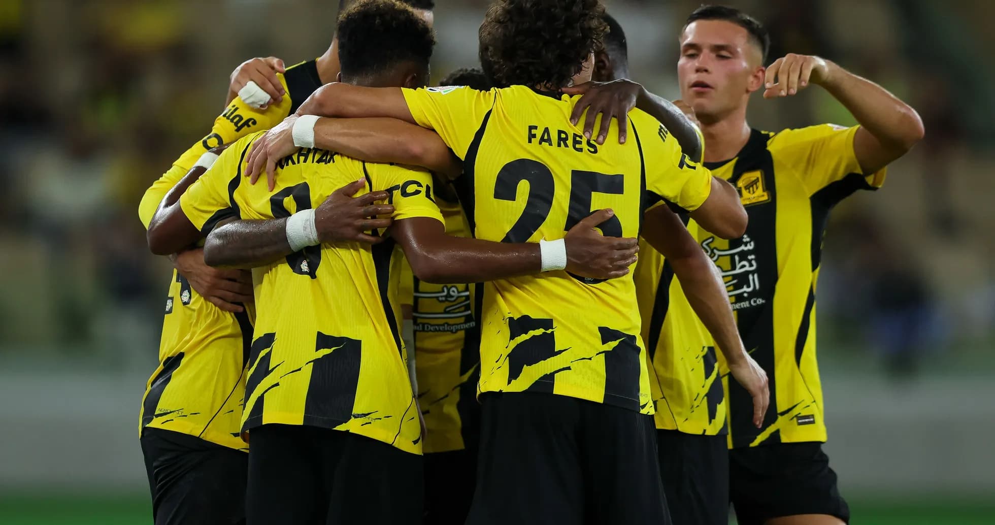 Players celebrating a goal in yellow jerseys