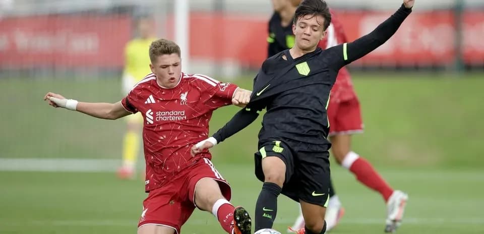 Two youth players contesting for the ball in match