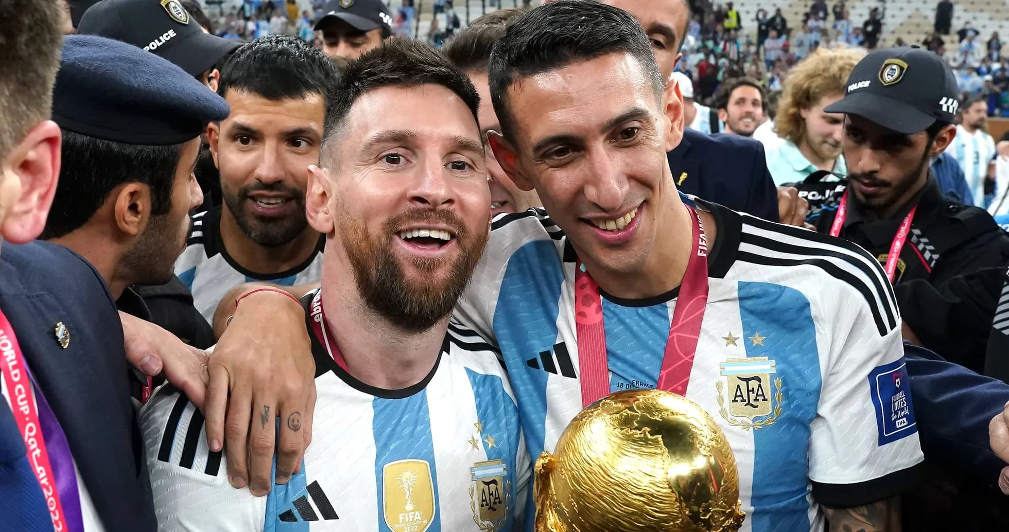 Lionel Messi and Angel Di Maria celebrating with trophy