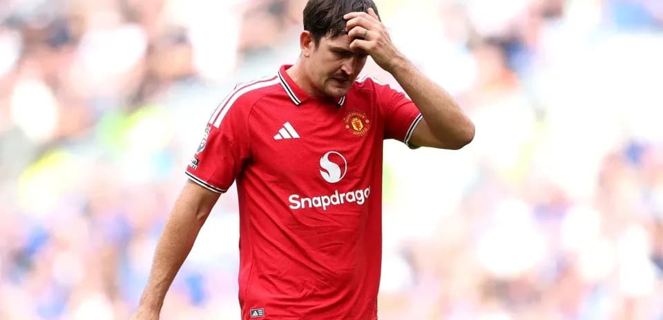 Player in red jersey walking off the pitch