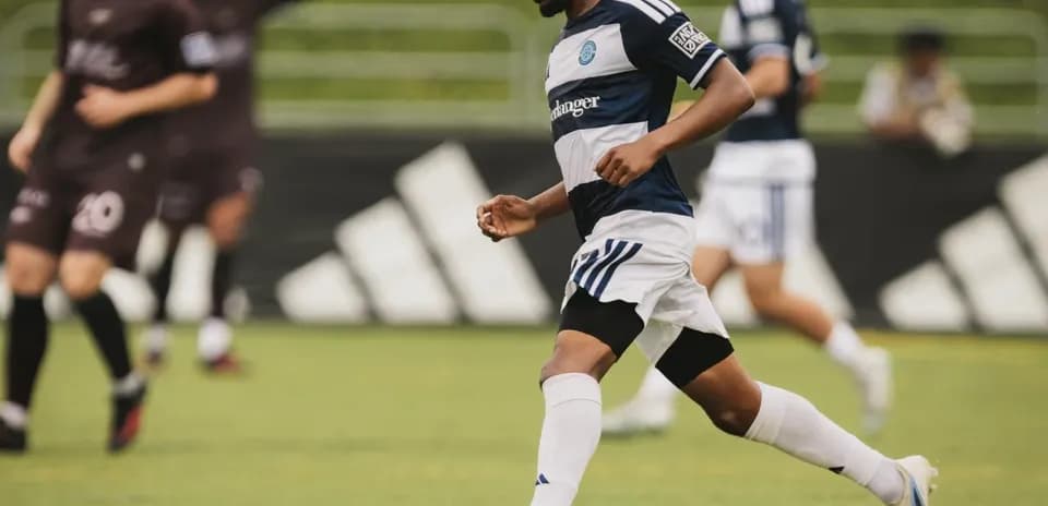 Player dribbling ball during Carolina Core match