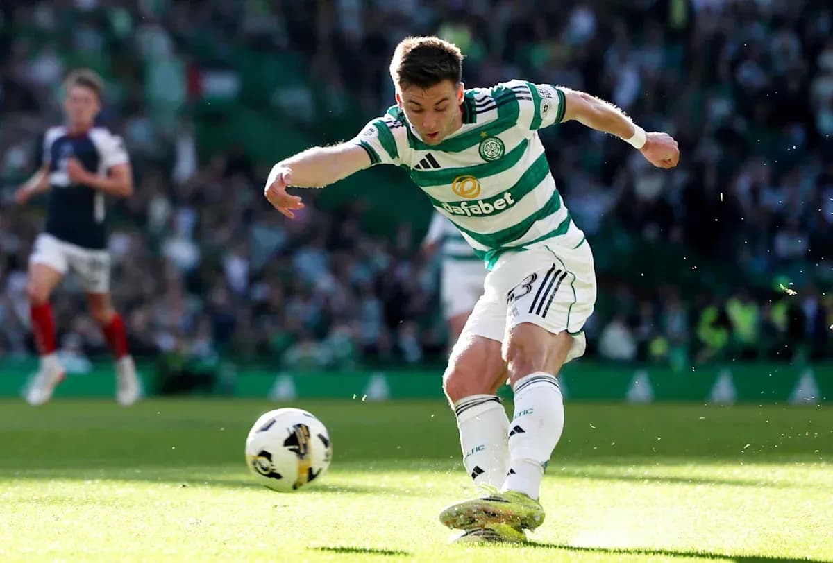 Celtic player kicking ball during match action