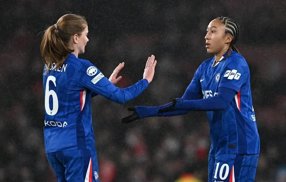 Two Chelsea players exchanging gestures on the pitch